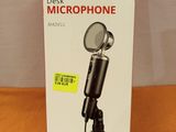 a box with a microphone on a table next to a mouse