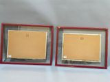 two framed pictures of a cat and a dog in a red frame