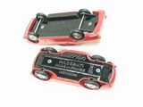 two red toy cars that are on a white surface