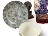 three bowls, a bowl, and a plate sitting on a table