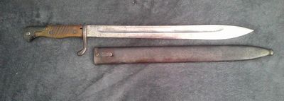 a knife that is laying on the ground next to a knife