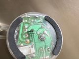 a close up of a green electronic device on a table