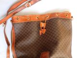 sac à main marron et beige, avec des anses en cuir marron sur un fond blanc