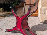 a red chair that is on the ground outside