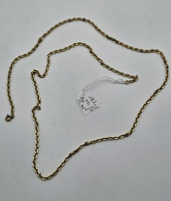 a close up of a gold chain with a tag on it