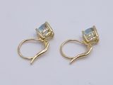 two pairs of gold earrings with blue topaz and white topaz stones