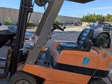 a forklift that is sitting on the side of the road