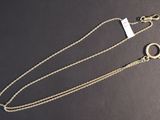 a close up of a gold chain with a ring on it