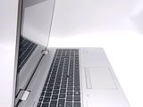 a silver laptop with a black keyboard on a white surface