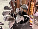 a bag of golf clubs sitting on the floor next to a bag of golf clubs