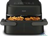 a black air fryer with french fries in it