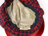 a red and blue hat on a white surface