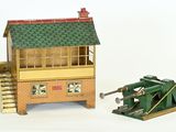 a small model of a building and a cannon