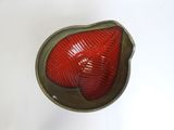 a red light that is sitting on a white surface