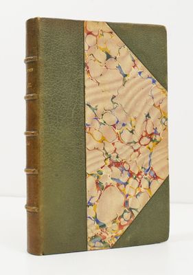 an old book with a green cover and a floral design on it