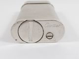 an old silver lighter sitting on top of a white surface