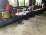 many chairs and tables in a room with a large window