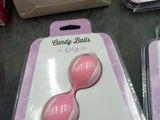 three pink candy balls in a package on a table