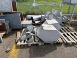 a pile of old appliances on a pallet in a yard