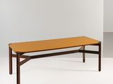 the table is made of wood and has a yellow top