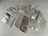 a lot of forks and spoons on the table