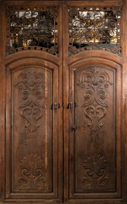 an image of a large wooden door with intricate carvings