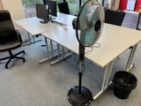 a fan that is sitting on a table in an office