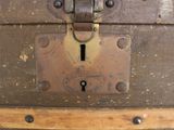 an old suitcase that has a lock on it