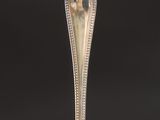 a silver spoon with a handle on a black background