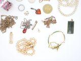many different types of jewelry laid out on a white surface