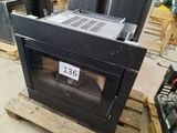 a black oven sitting on top of a pallet in a warehouse