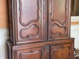 a large wooden cabinet in the corner of a room