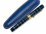 a close up of a pen and a pen case on a white surface