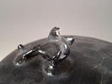 a small bird sitting on top of a black object