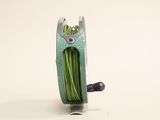 a spool with a spool of green thread attached to it