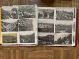 an open book that has pictures of mountains and buildings on it