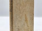 an old book sitting on top of a white table
