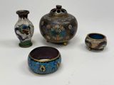 four different types of vases and bowls on a white surface