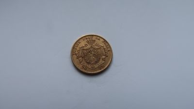 a close up of a coin on a white surface