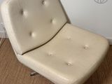 a chair that is sitting on the floor in front of a wall