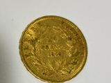 a gold coin sitting on top of a white table
