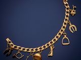 a gold bracelet with charms and a heart on it