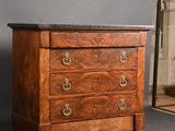 an antique chest of drawers with a mirror in the background
