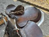 a horse saddle and a rope on the ground