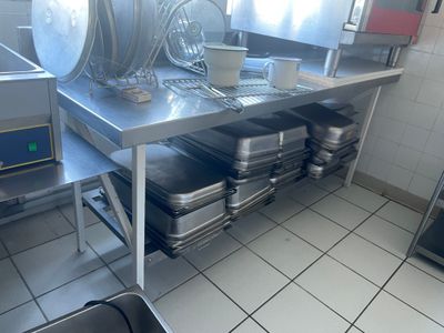 de nombreuses casseroles et poêles posées sur le plan de travail de la cuisine
