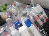 a pile of toiletries in a plastic bag on the floor