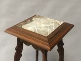 an old wooden table with a marble top on a white background