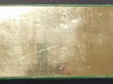 an image of a gold plate on a black surface