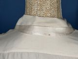 a close up of a white shirt on a mannequin mannequin