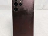 a close up of the back of a brown phone